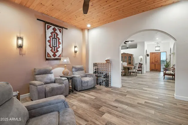 a living room with furniture and large windows