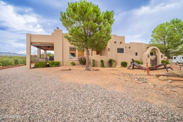 a view of a house with a backyard