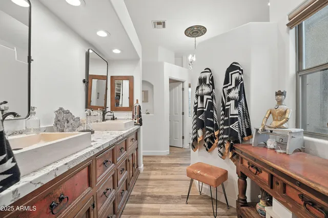 a bedroom with a bed couch and a window