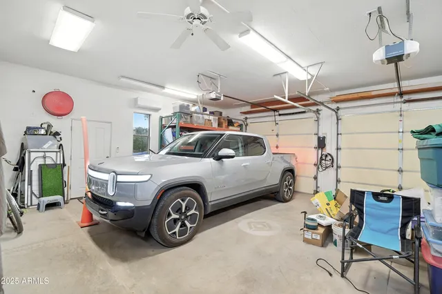 an aerial view of a house with a garden and mountain view in back