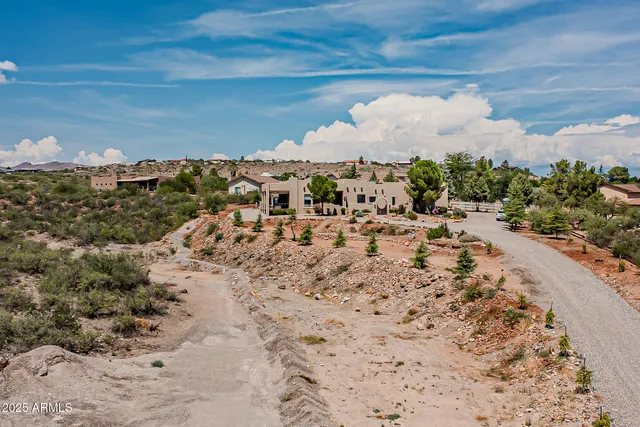 an aerial view of a house with a swimming pool a yard and a garage