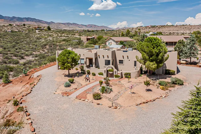 an aerial view of residential house and car parked