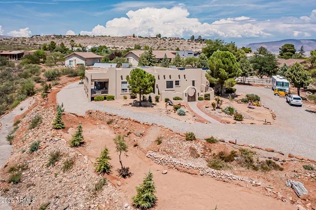 a view of a house with a yard and potted plants