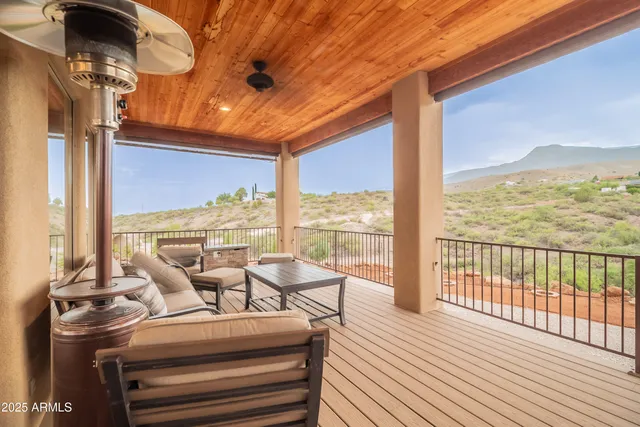 a kitchen with stainless steel appliances granite countertop a sink dishwasher a stove a refrigerator with white cabinets and wooden floor