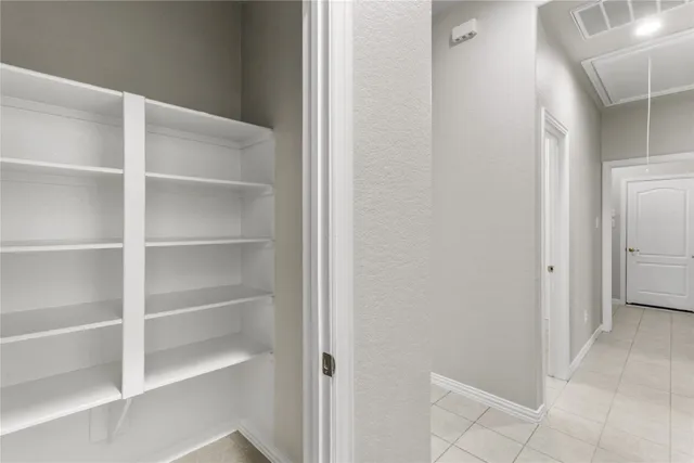 a view of kitchen with granite countertop cabinets and refrigerator
