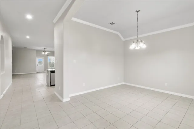 a view of a room with window and chandelier fan