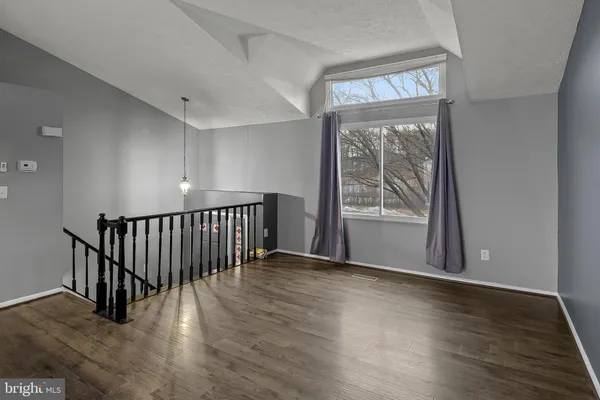a view of an entryway with wooden floor