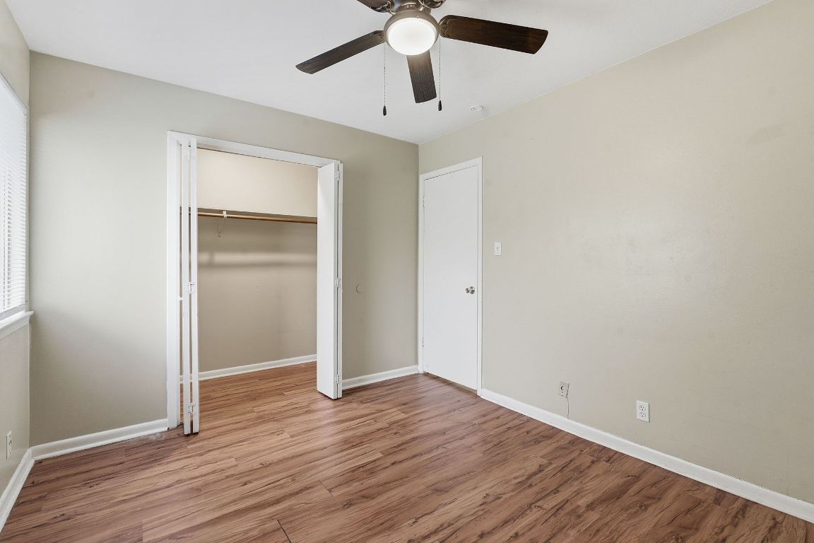 8809 Dawnridge Circle, Unit 102 Austin, TX 78757 - Photo 13 of 18 a view of an empty room with wooden floor