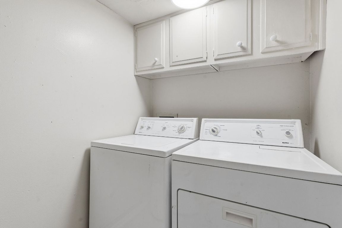 8809 Dawnridge Circle, Unit 102 Austin, TX 78757 - Photo 15 of 18 a utility room with dryer and cabinets