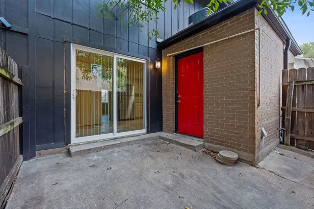 a view of backyard with red door