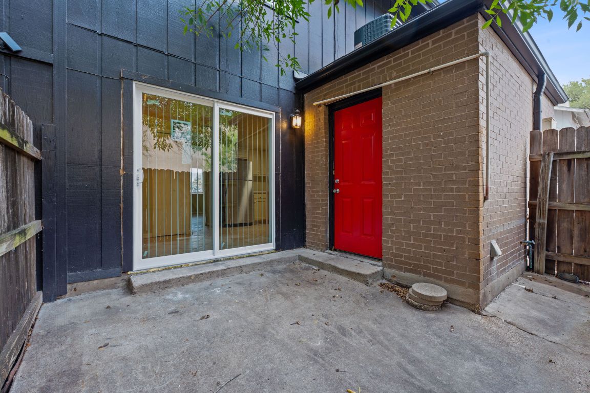 8809 Dawnridge Circle, Unit 102 Austin, TX 78757 - Photo 16 of 18 a view of backyard with red door