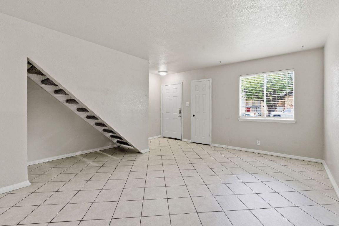 8809 Dawnridge Circle, Unit 102 Austin, TX 78757 - Photo 3 of 18 a view of an empty room and stairs