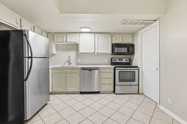 a kitchen with a refrigerator sink and stove