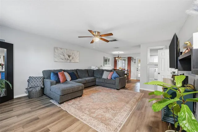 a view of a house with brick walls and a yard with plants