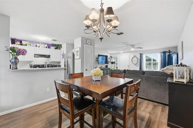 a living room with furniture a flat screen tv and a large window