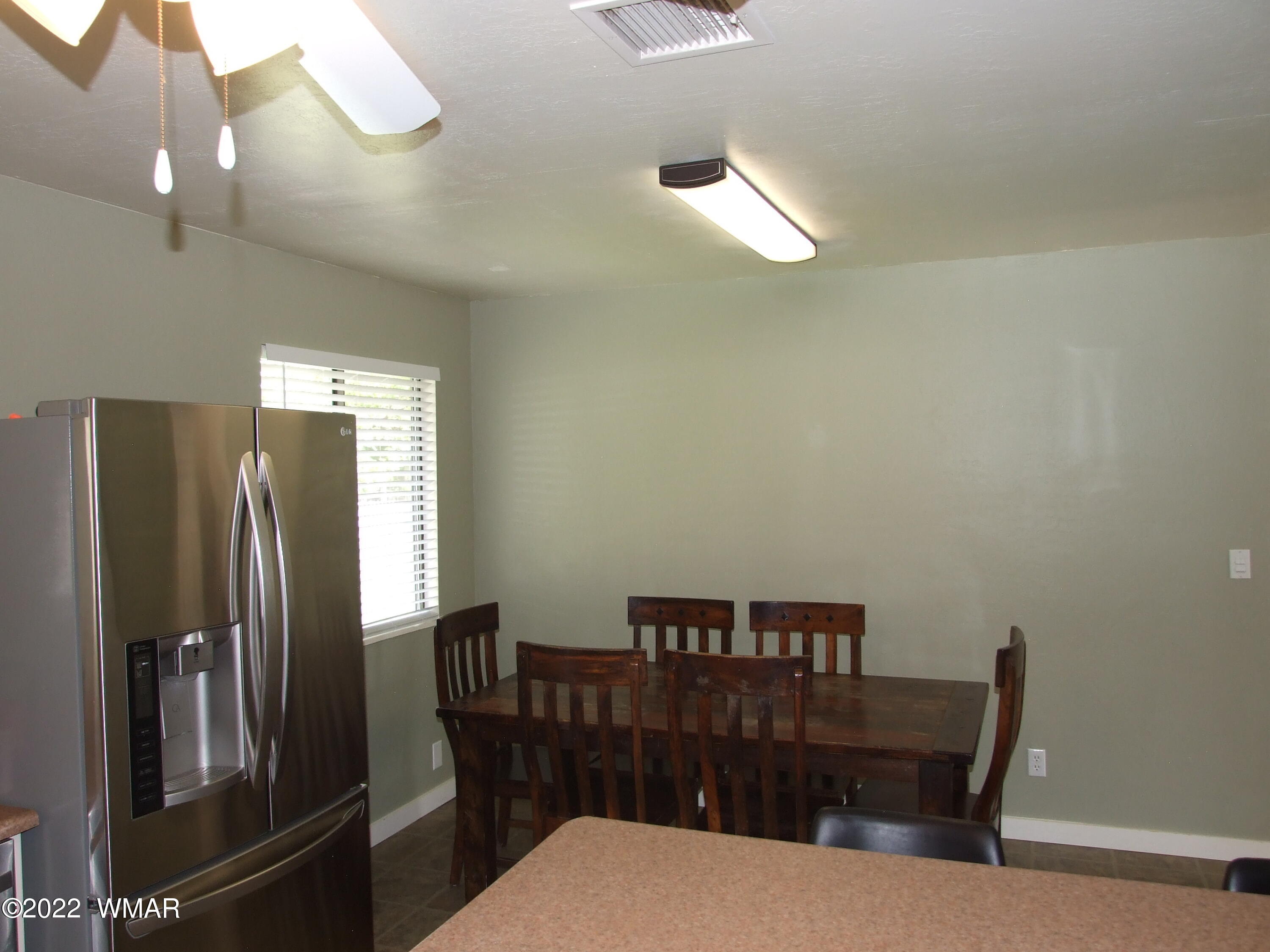 49 North 4th W Street Snowflake, AZ 85937 - Photo 24 of 34 a kitchen with a table and refrigerator
