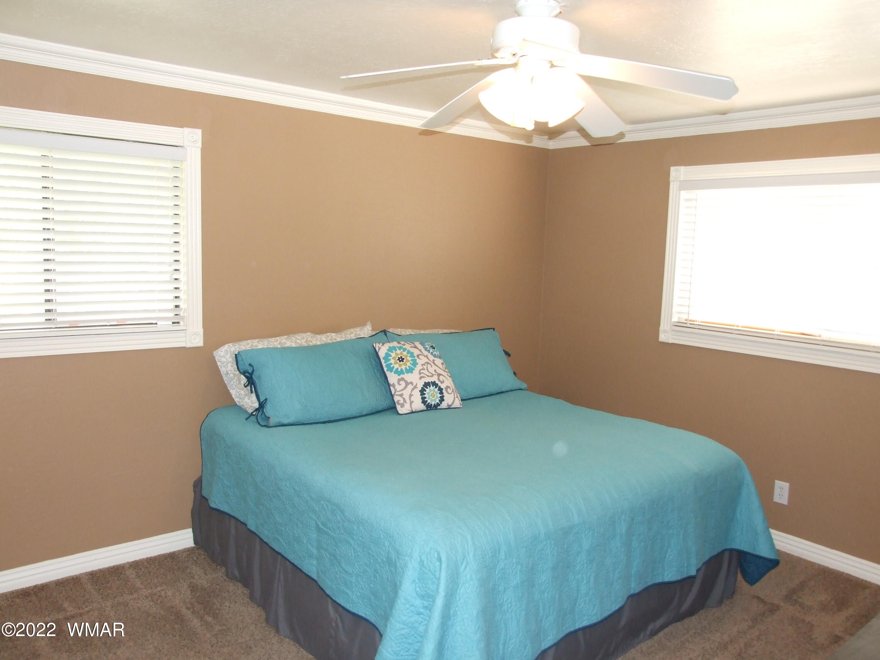 49 North 4th W Street Snowflake, AZ 85937 - Photo 30 of 34 a bedroom with a bed and a chandelier