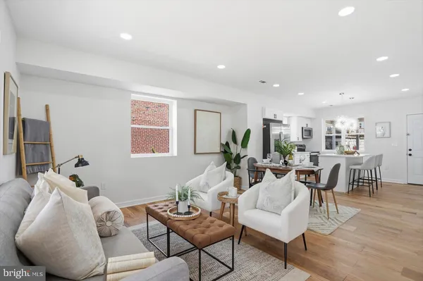 a living room with furniture kitchen and a window