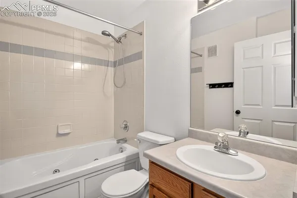 a bathroom with a sink toilet tub and shower