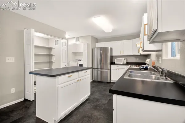 a kitchen with a sink stove and refrigerator