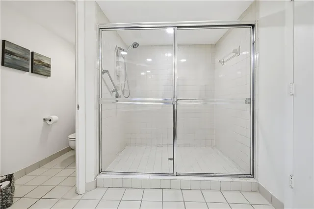 a bathroom with a granite countertop sink a mirror and a shower