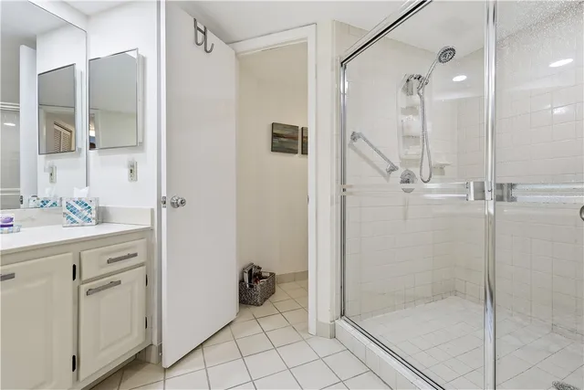 a bathroom with a shower sink and mirror