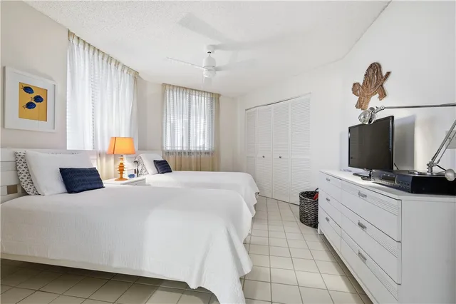 a bedroom with a bed and flat screen tv
