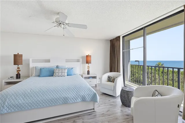 a bedroom with bed couch and window