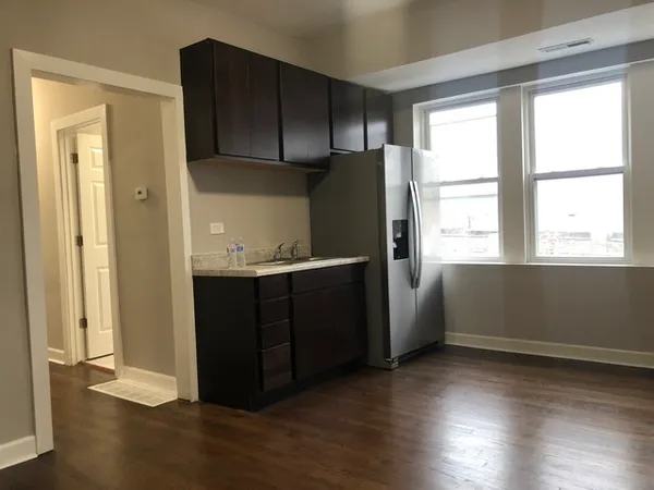 a kitchen with a refrigerator and window