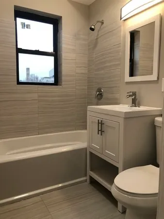 a bathroom with a toilet a sink and mirror