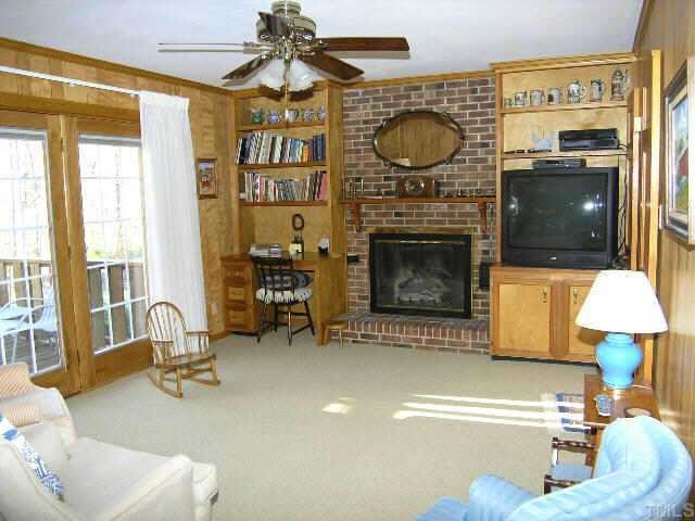 1105 Ralph Drive Cary, NC 27511 - Photo 5 of 12 a living room with furniture a flat screen tv and a fireplace