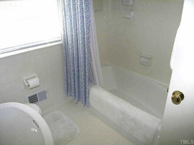 1105 Ralph Drive Cary, NC 27511 - Photo 8 of 12 a bathroom with a tub and shower