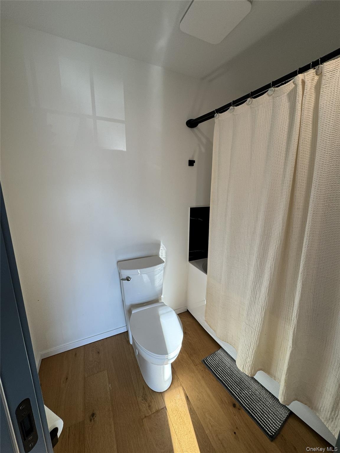 241 Main Street Cold Spring, NY 10516 - Photo 15 of 29 a white toilet sitting next to a shower curtain