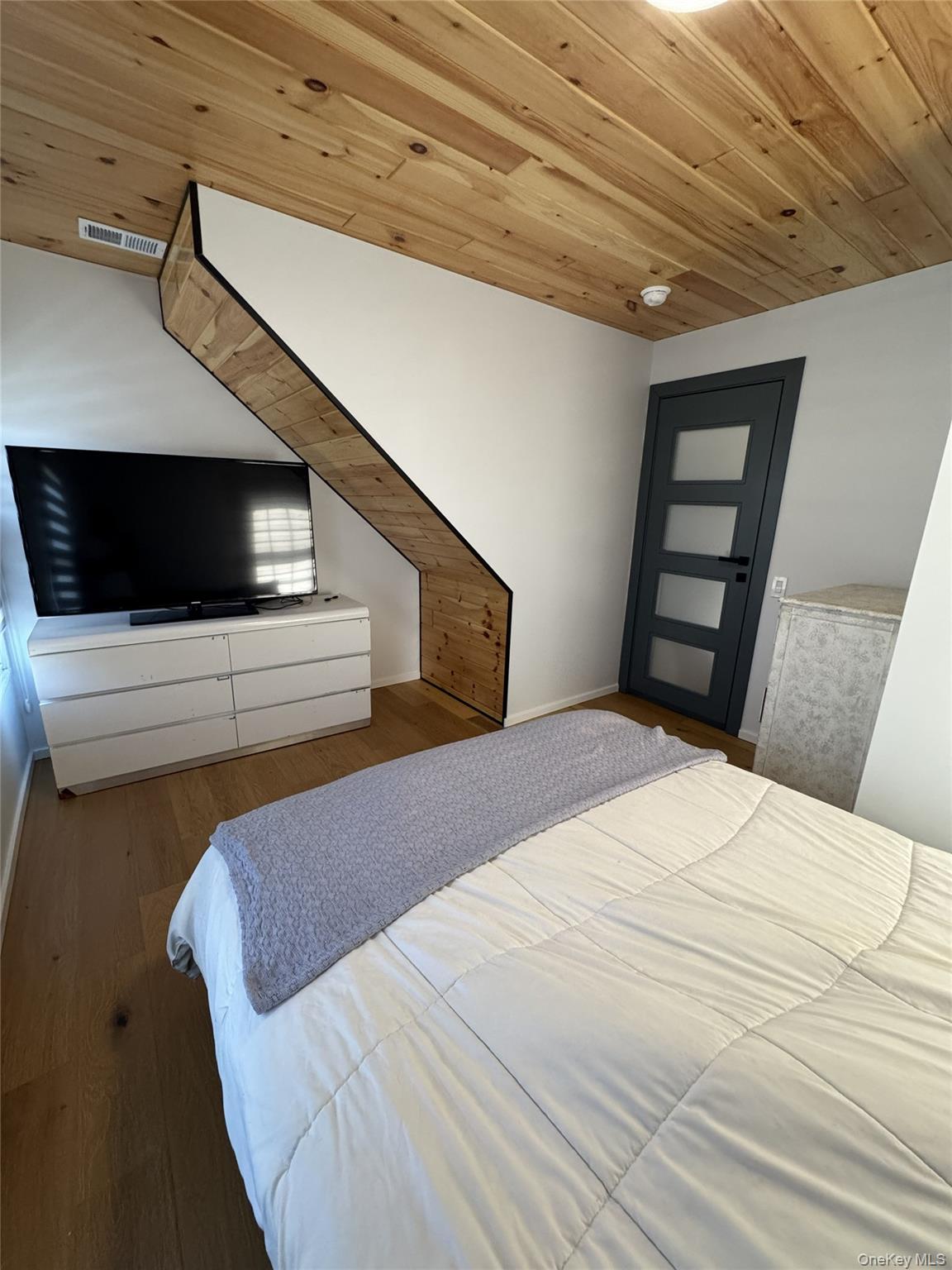 241 Main Street Cold Spring, NY 10516 - Photo 18 of 29 a bedroom with a bed and a flat screen tv