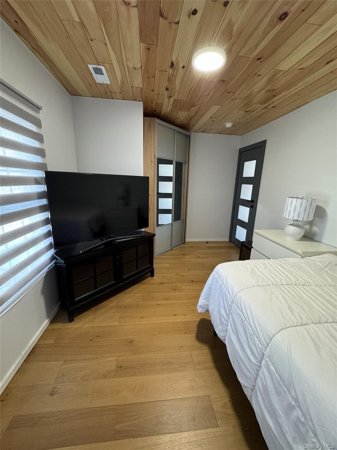 241 Main Street Cold Spring, NY 10516 - Photo 23 of 29 a bedroom with a bed and a flat screen tv