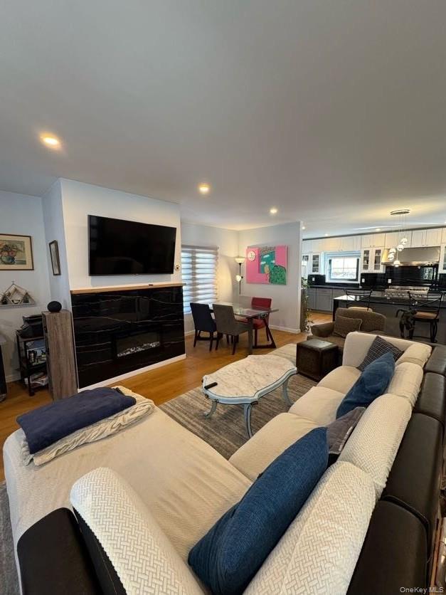 241 Main Street Cold Spring, NY 10516 - Photo 6 of 29 a living room with furniture a flat screen tv and kitchen view