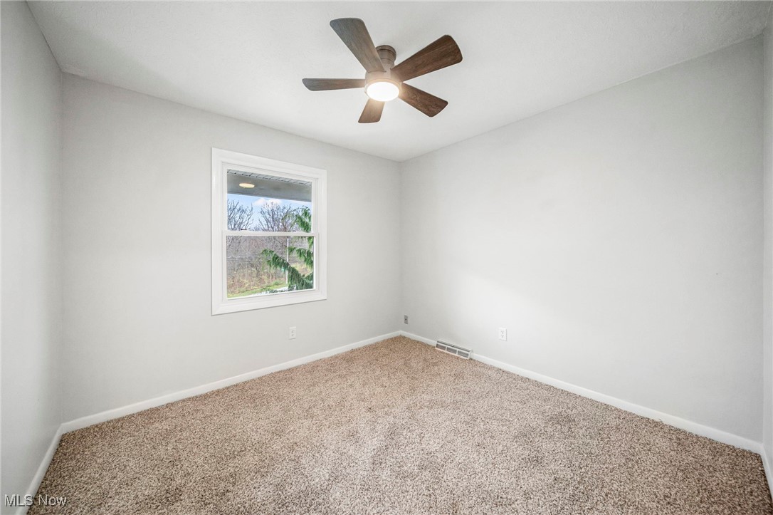 91 Paradise Road Painesville, OH 44077 - Photo 24 of 39 Unfurnished room featuring carpet and a ceiling fan