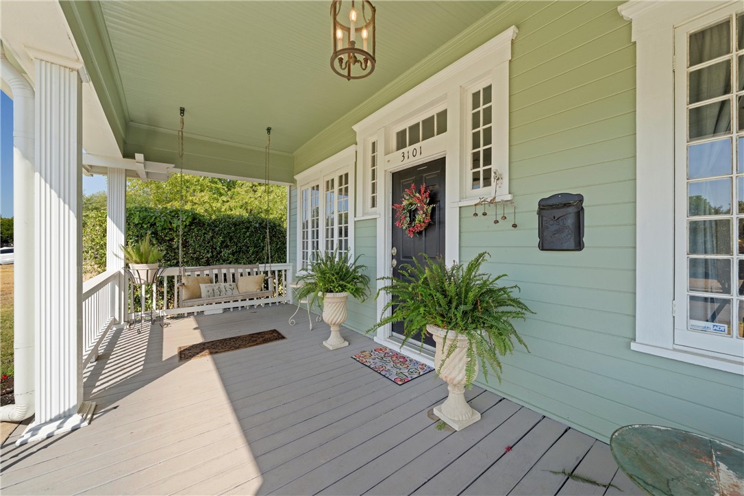 a porch with seating space and hardwood floor