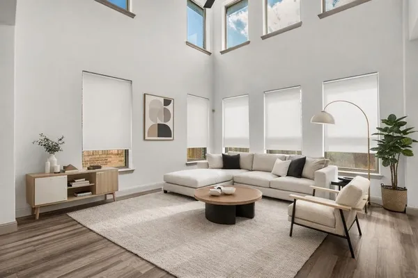 a living room with furniture and wooden floor