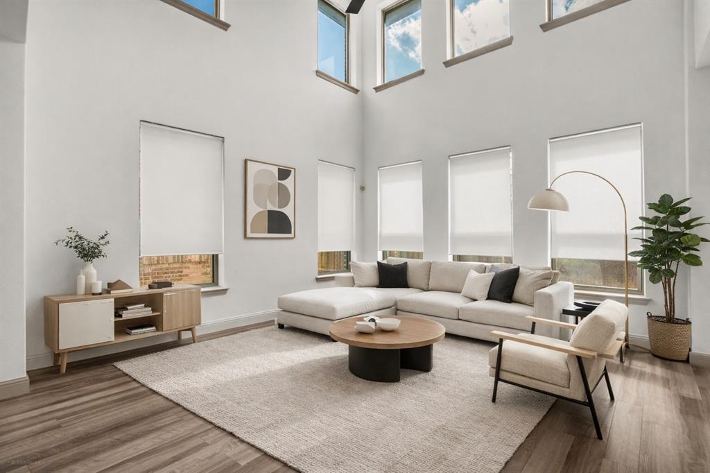 a living room with furniture and wooden floor