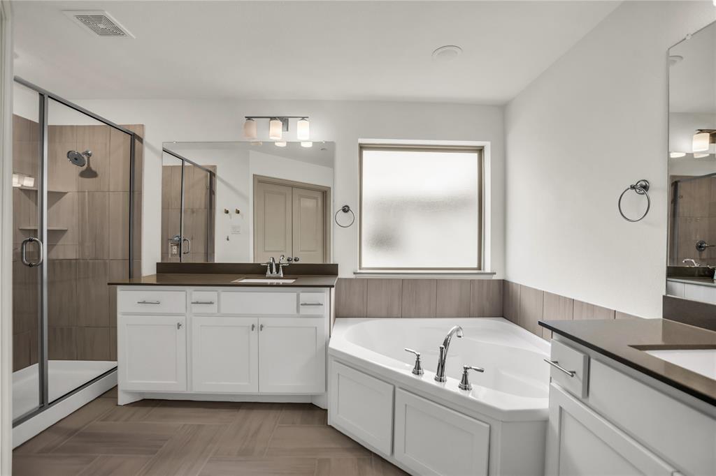 999 Emil Place Allen, TX 75013 - Photo 11 of 29 a bathroom with a granite countertop tub a sink and a shower