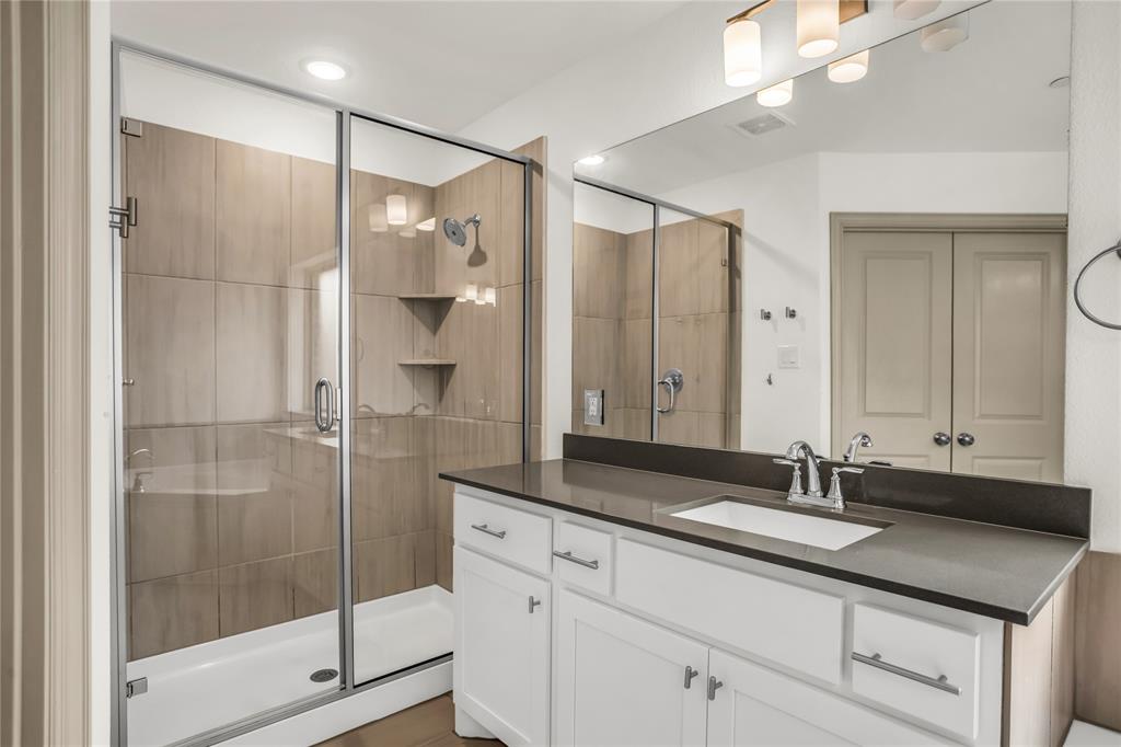 999 Emil Place Allen, TX 75013 - Photo 12 of 29 a bathroom with a shower sink and mirror