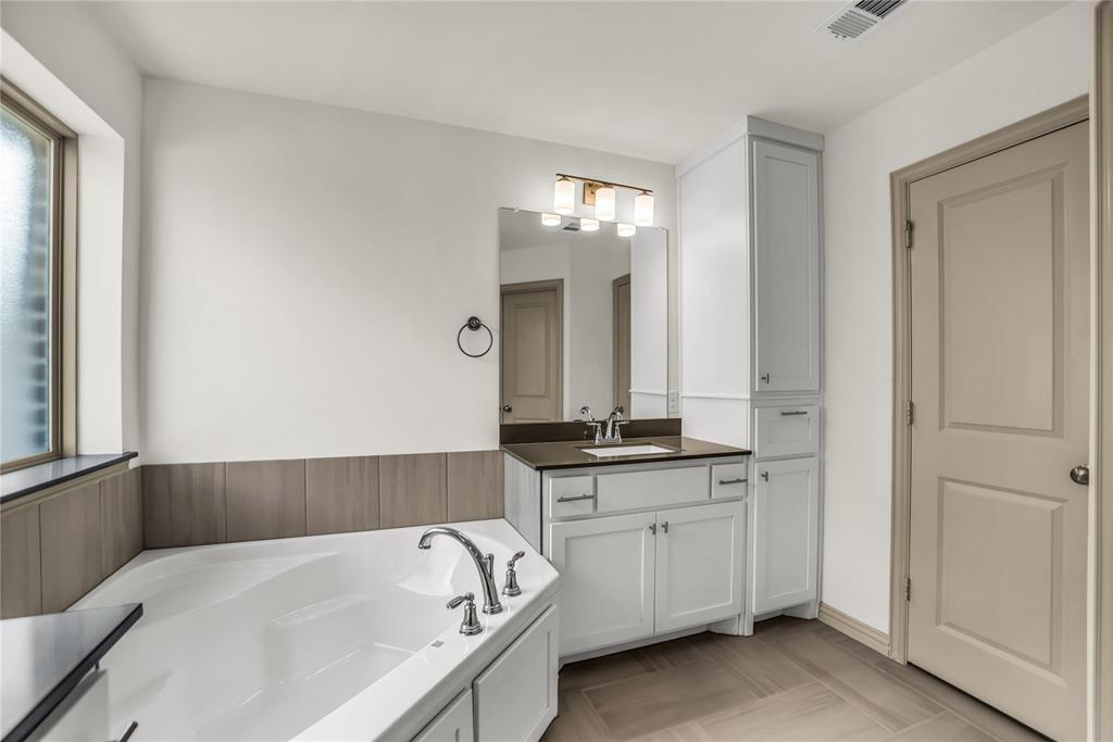999 Emil Place Allen, TX 75013 - Photo 13 of 29 a bathroom with a bathtub and a sink