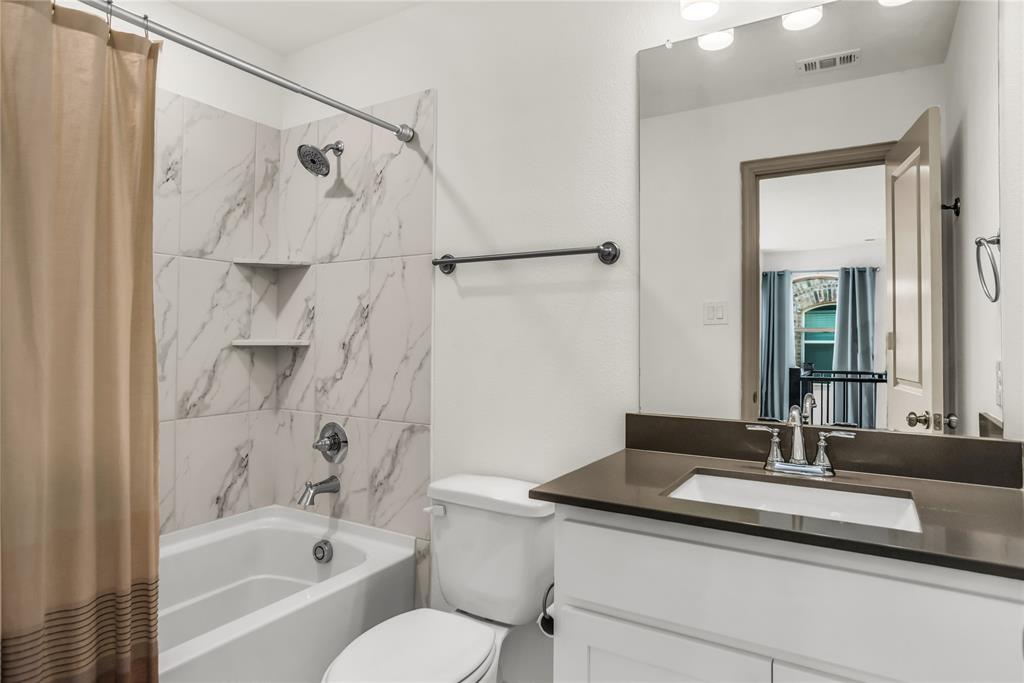 999 Emil Place Allen, TX 75013 - Photo 17 of 29 a bathroom with a granite countertop sink a toilet and shower