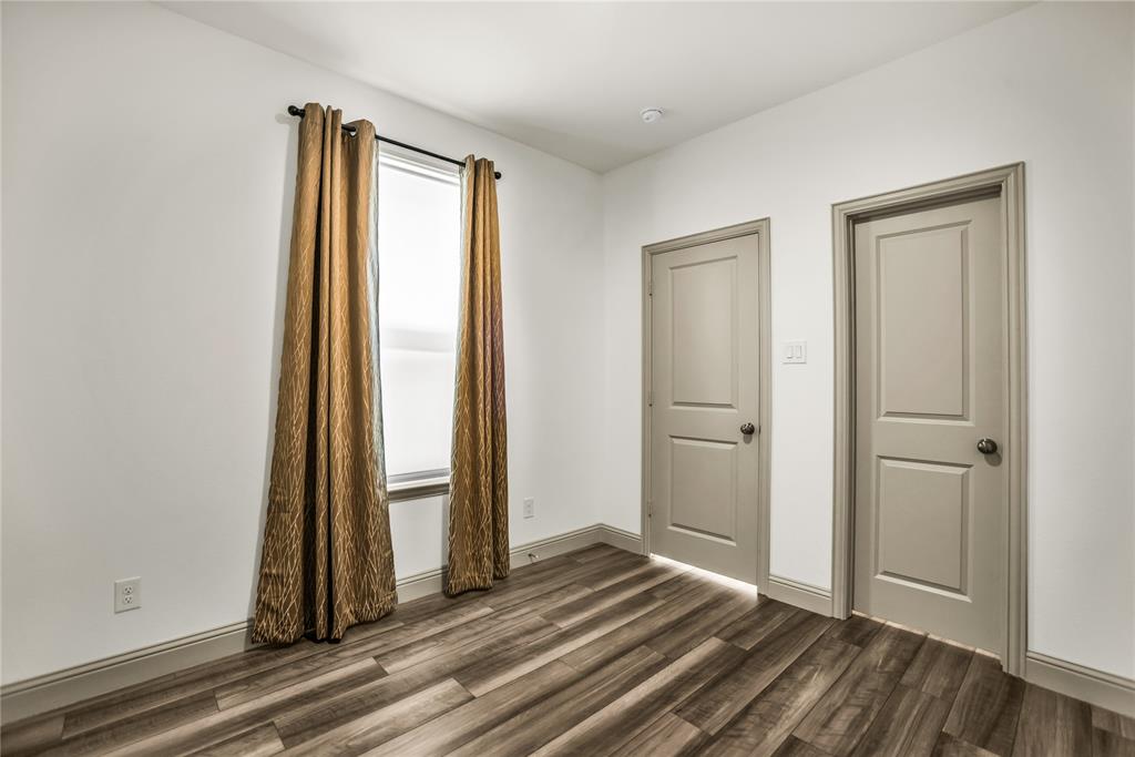 999 Emil Place Allen, TX 75013 - Photo 18 of 29 a view of a room with wooden floor and a bathroom