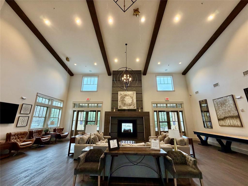 999 Emil Place Allen, TX 75013 - Photo 25 of 29 a living room with furniture a fireplace and a flat screen tv