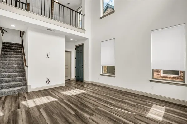 a view of a bedroom with wooden floor