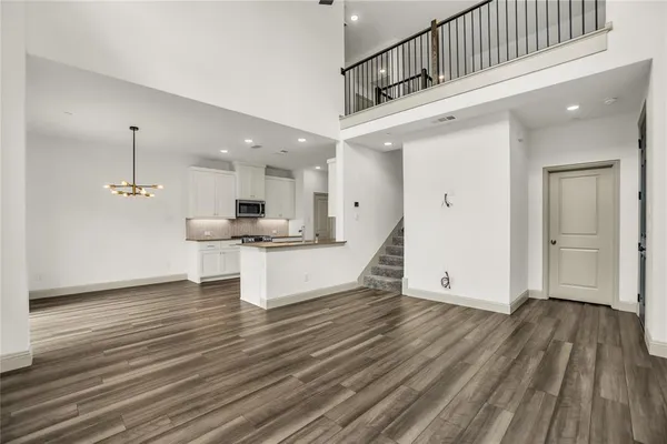 a view of a kitchen with kitchen island a sink stainless steel appliances and cabinets
