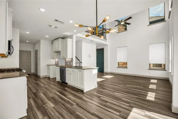 a kitchen with stainless steel appliances granite countertop a sink a stove and a refrigerator