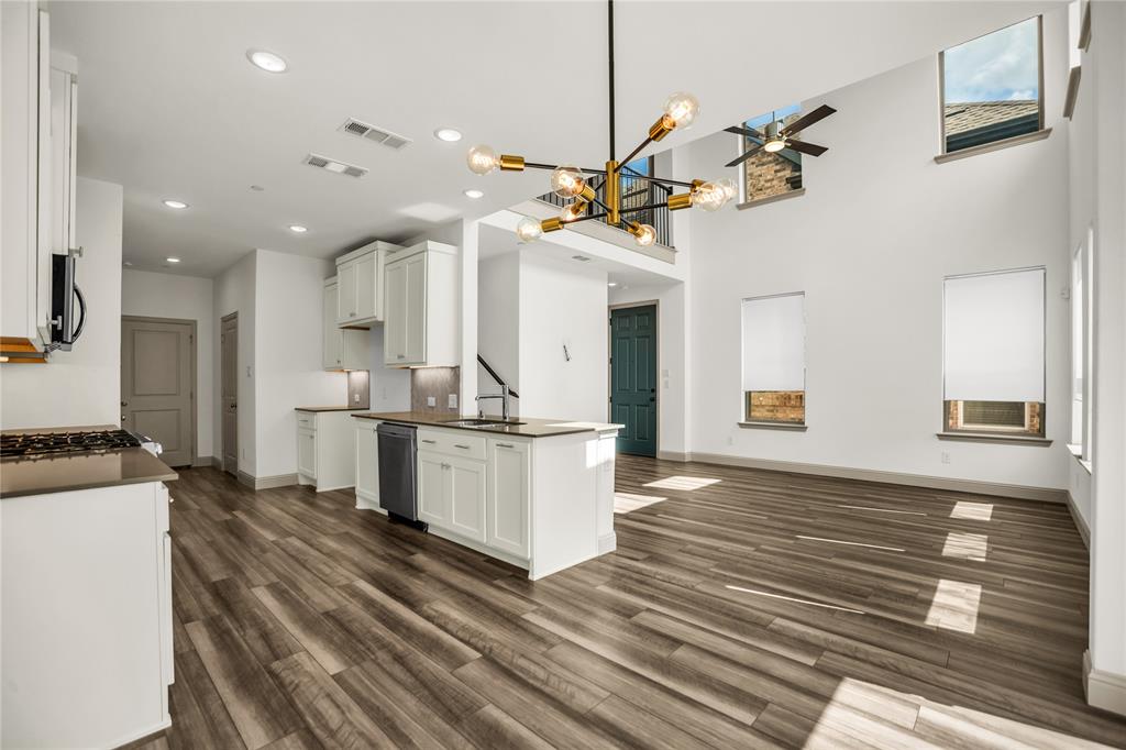 999 Emil Place Allen, TX 75013 - Photo 6 of 29 a view of a kitchen with kitchen island a sink stainless steel appliances and cabinets